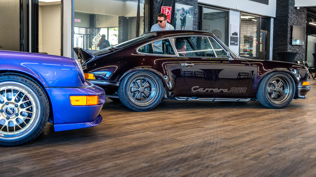 A dark Porsche Carrera RSR displayed inside the Park Place showroom