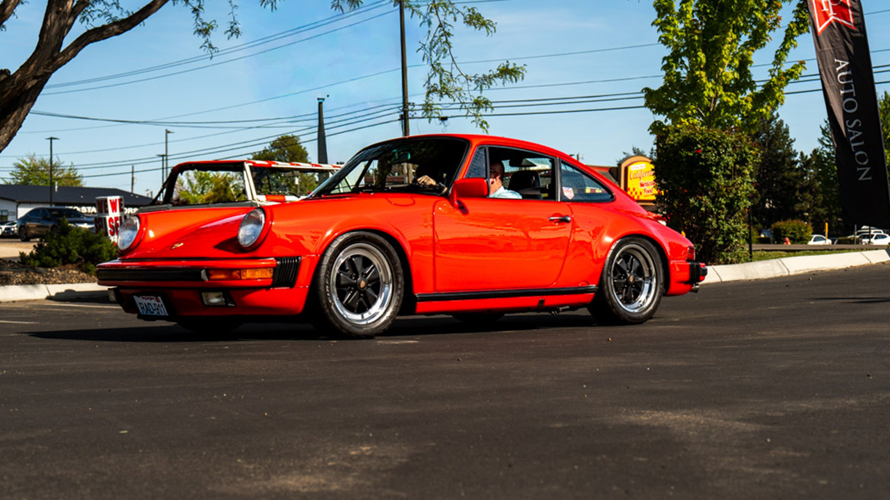 A red air-cooled Porsche 911 arriving outside Park Place