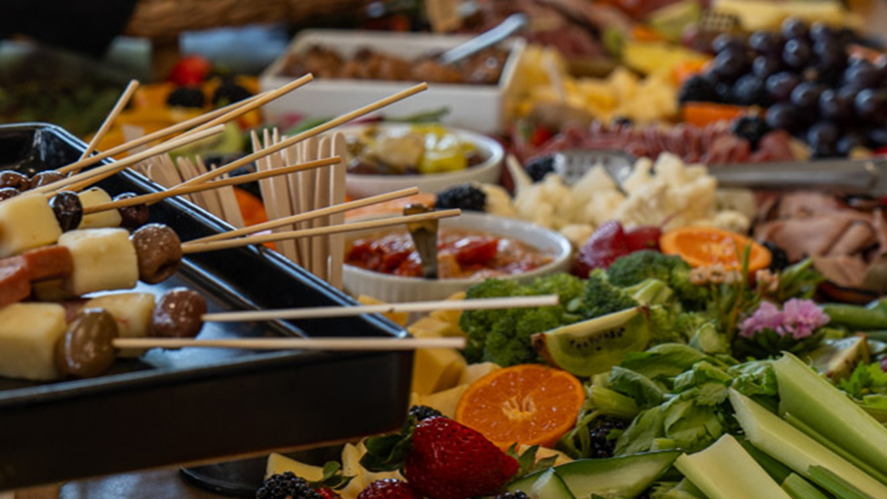 Fruit, vegetables, meats, cheeses, and skewers arranged for guests