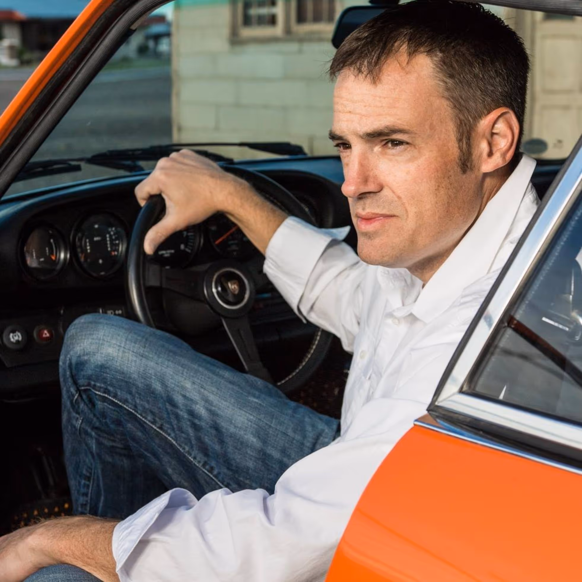 Nathan Merz beside a Porsche