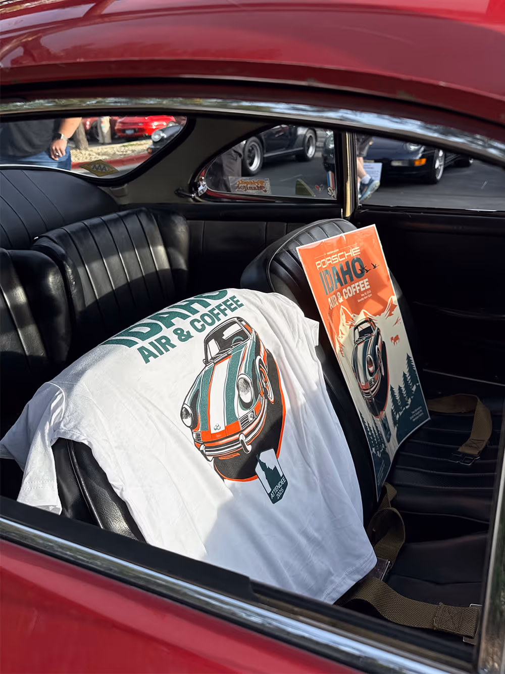 A Porsche-themed shirt and printed artwork on a car seat