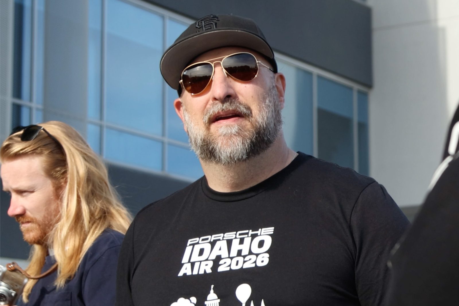 A member of the Idaho Air parking crew in a 2026 crew tee, cap, and aviator sunglasses
