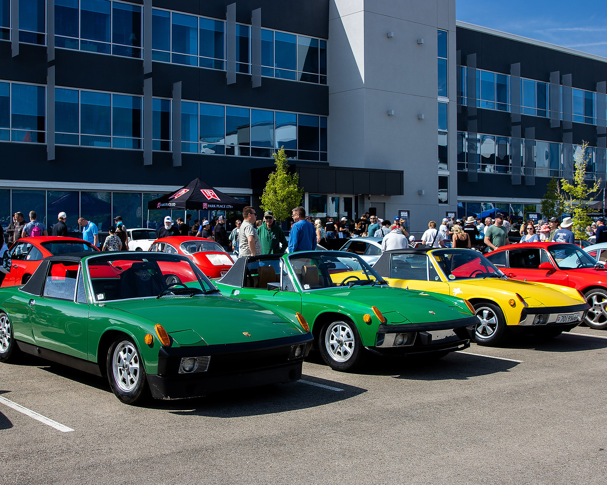 Row of air-cooled Porsche 914s at Idaho Air, with the crowd behind